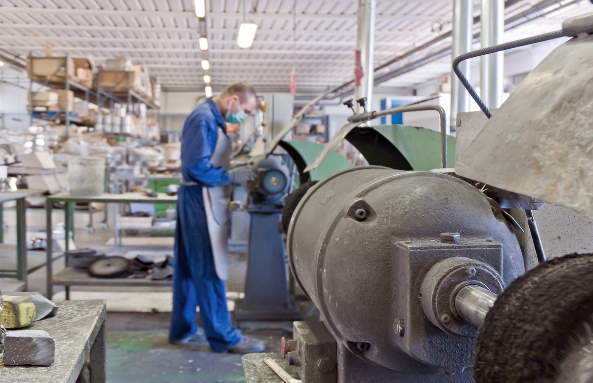 Technician examining an industrial dust sample for material and particle characteristics.