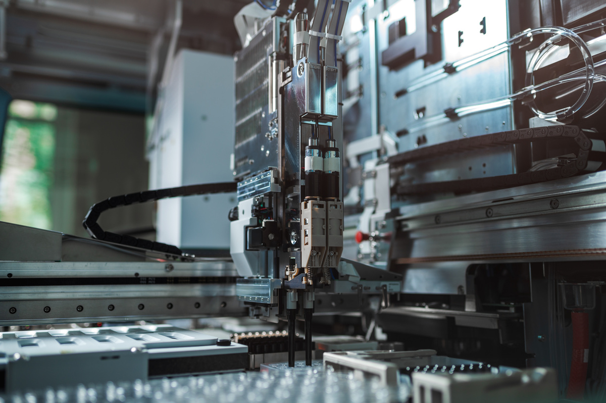 Robotic end-of-arm tooling gripping a component during automated production.