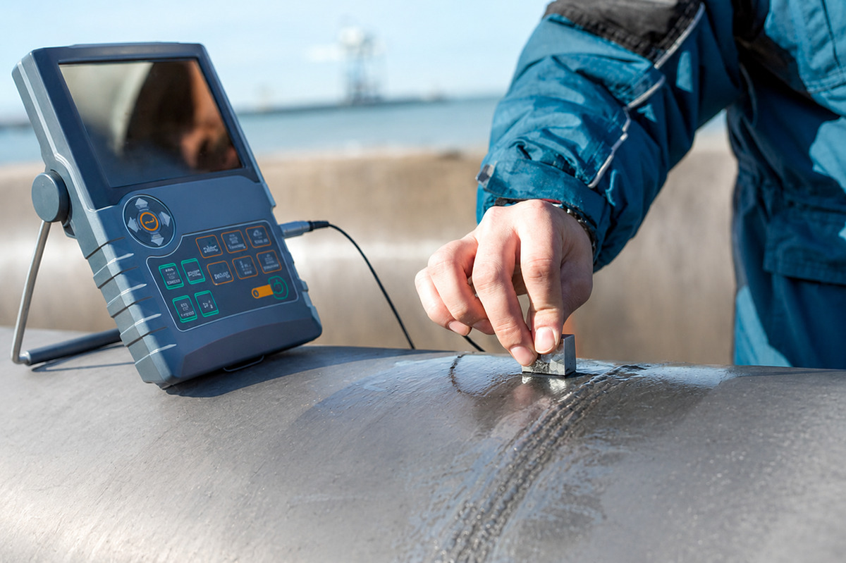 Technician performing nondestructive examination on a pressure-vessel weld.
