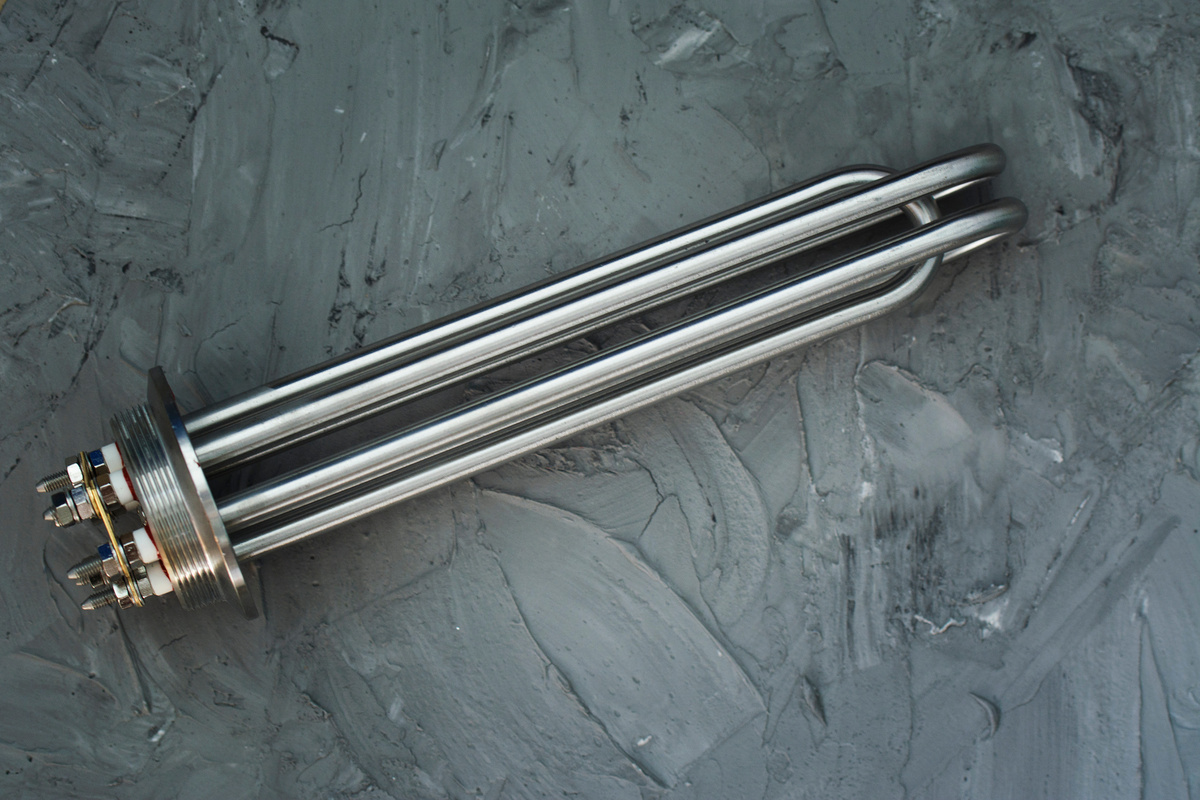 Industrial electric immersion heater with multiple tubular heating elements.