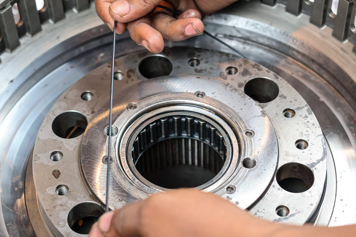 Technician inspecting an O-ring seal and its fit within an industrial component.