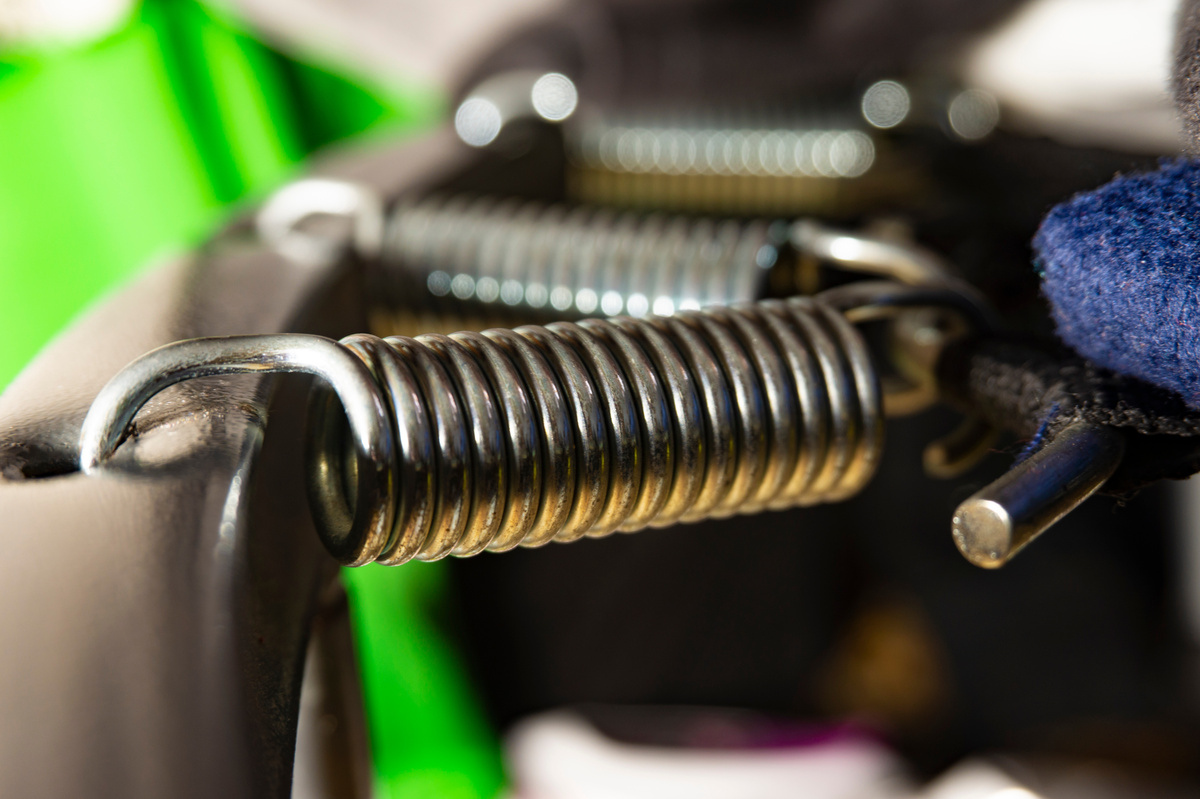 Close-up of the hook and coiled body of an industrial extension spring.
