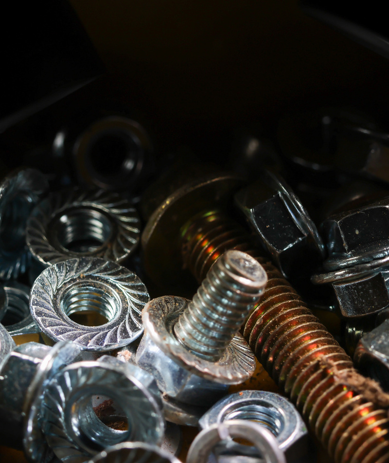 Close-up of a structural steel connection with bolted beams and a welded column joint, showing heavy-duty fasteners used in commercial or industrial construction.